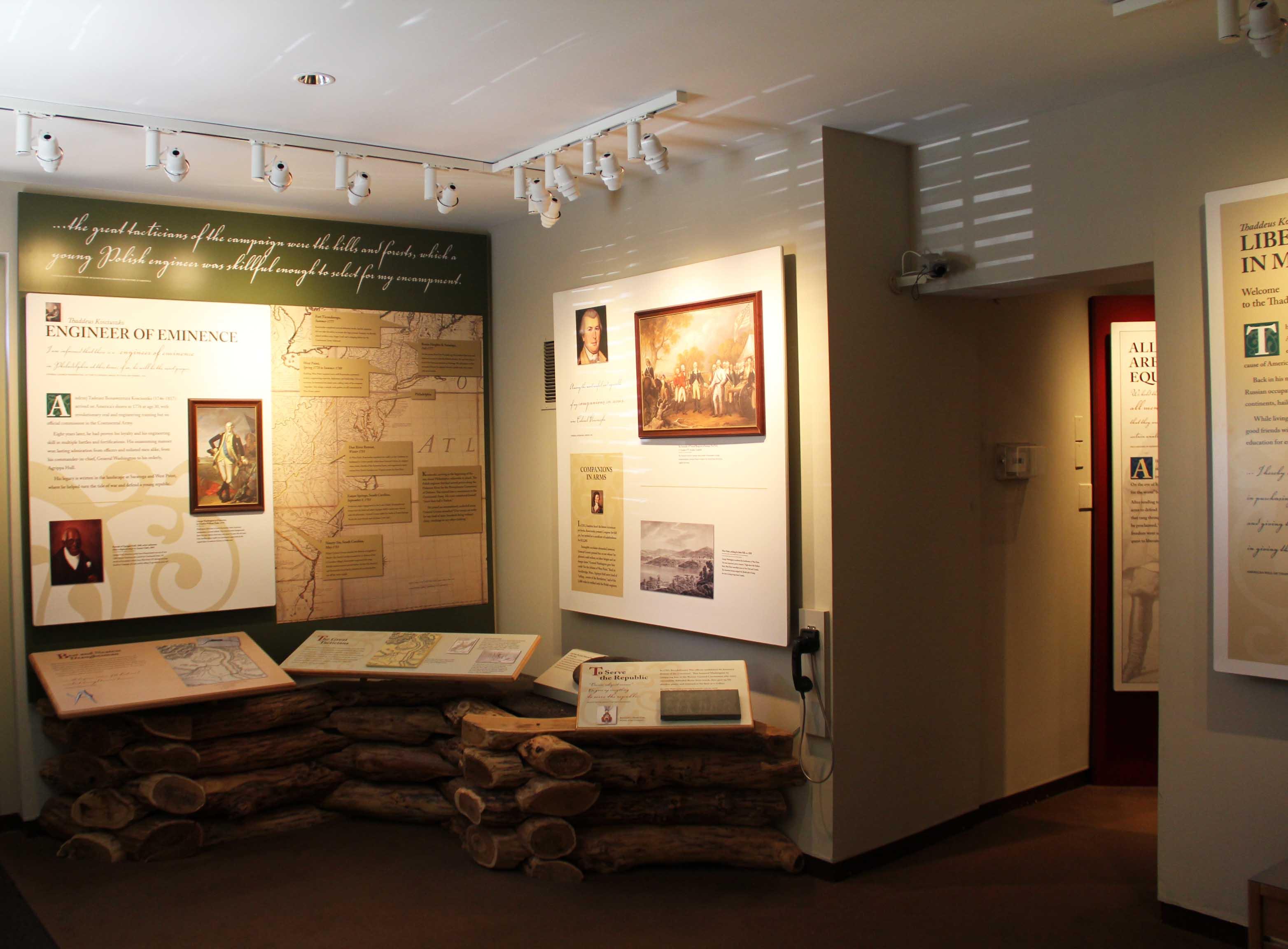 Photo of exhibit area with exhibit panels showing images, text, and a map of the eastern U.S.