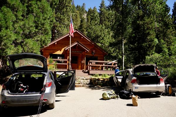 Cars parked in front of a rustic building