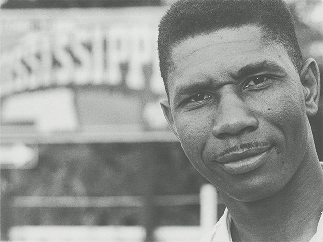Close up black and white portrait of a black man with a thin mustache