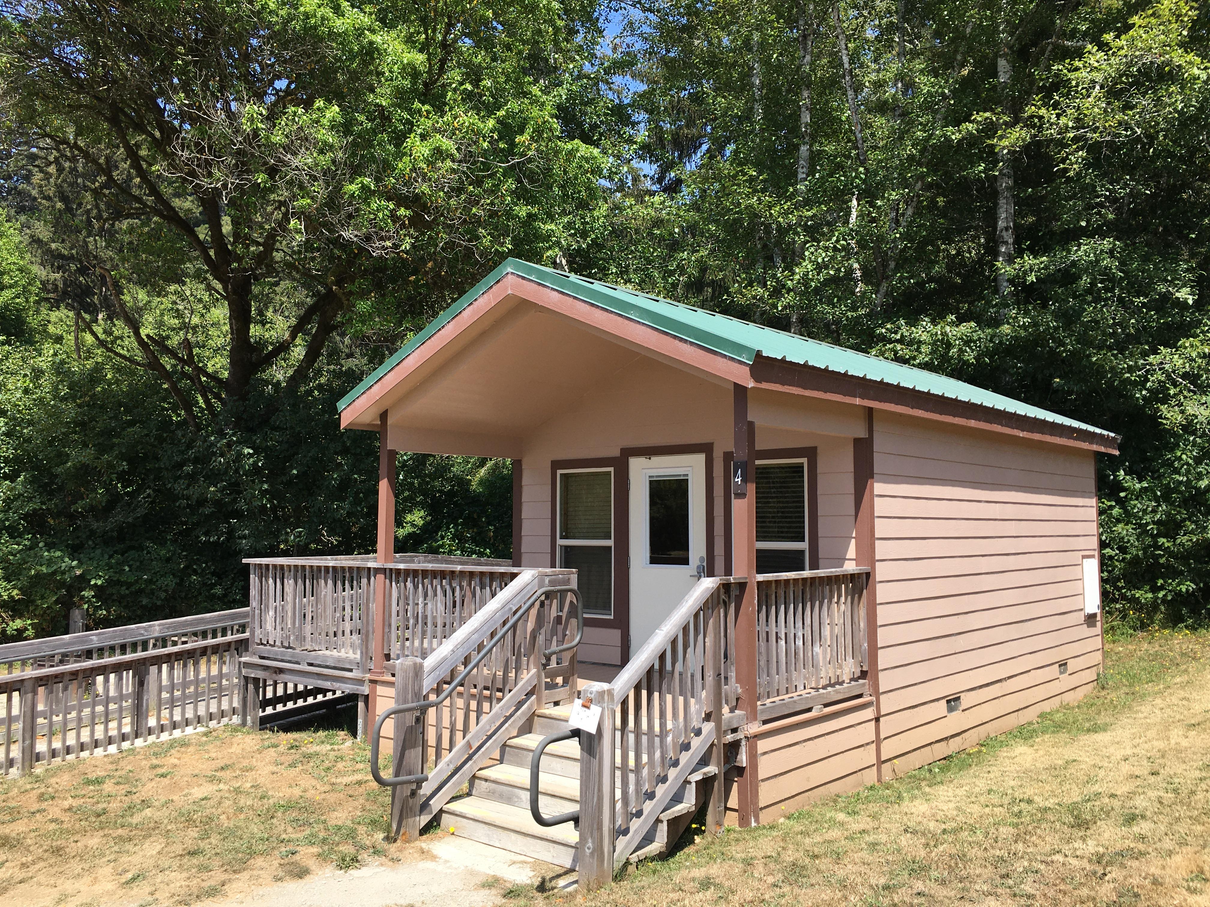 Brown and green building with ADA ramp.