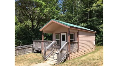 Brown and green building with ADA ramp.