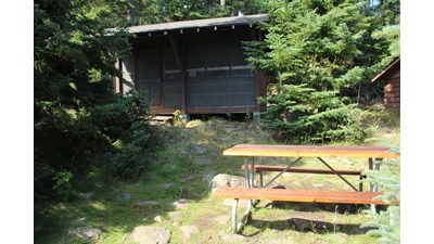 Campground shelter with picnic table.