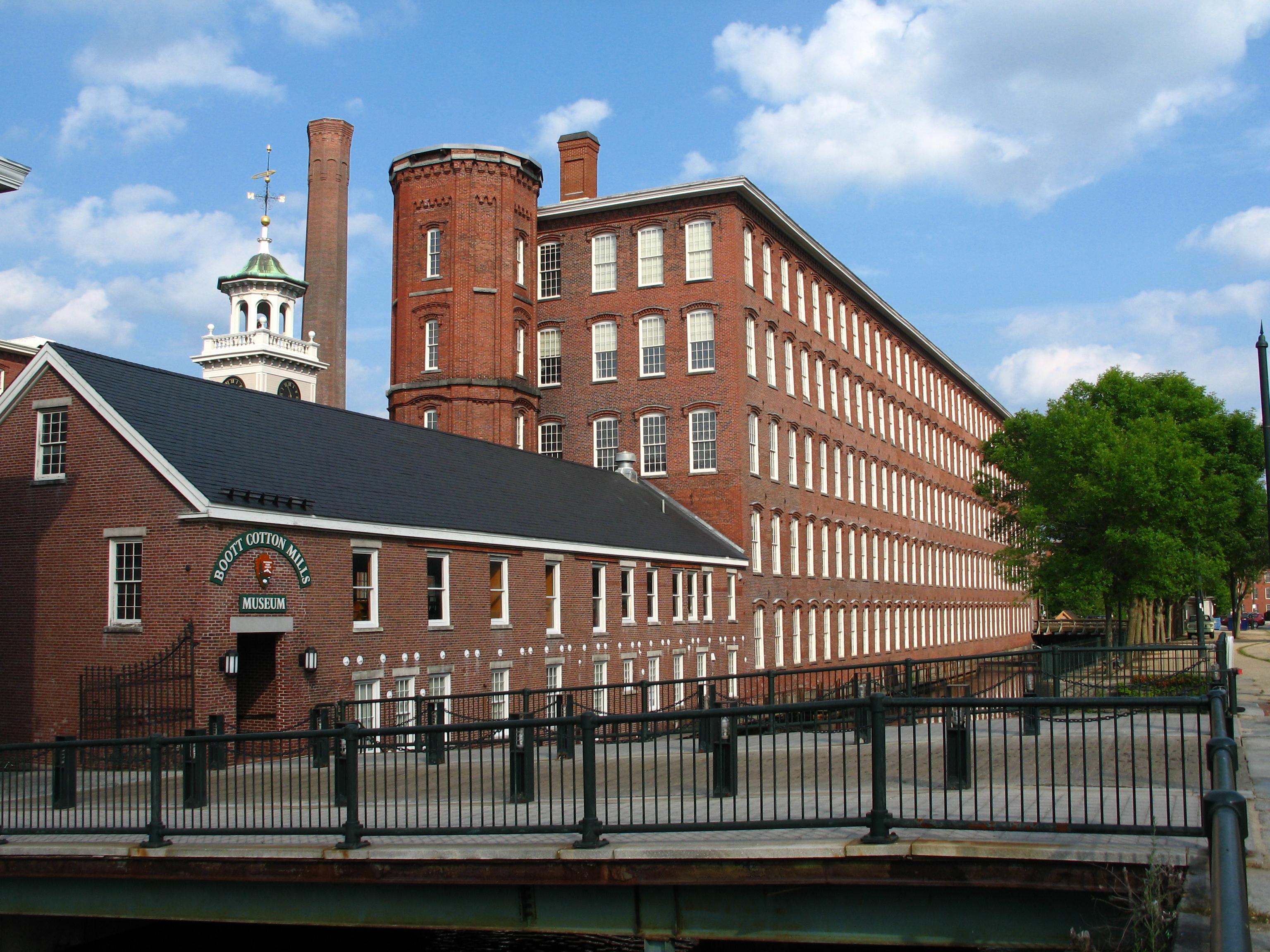 5 story brick factories with a clocktower surrounding a central courtyard