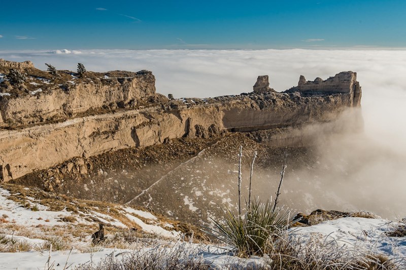 Saddle Rock rises above the Clouds A unique rock formation is seen above a layer of clouds.