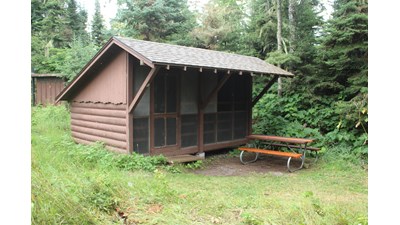 Campground shelter with picnic table.