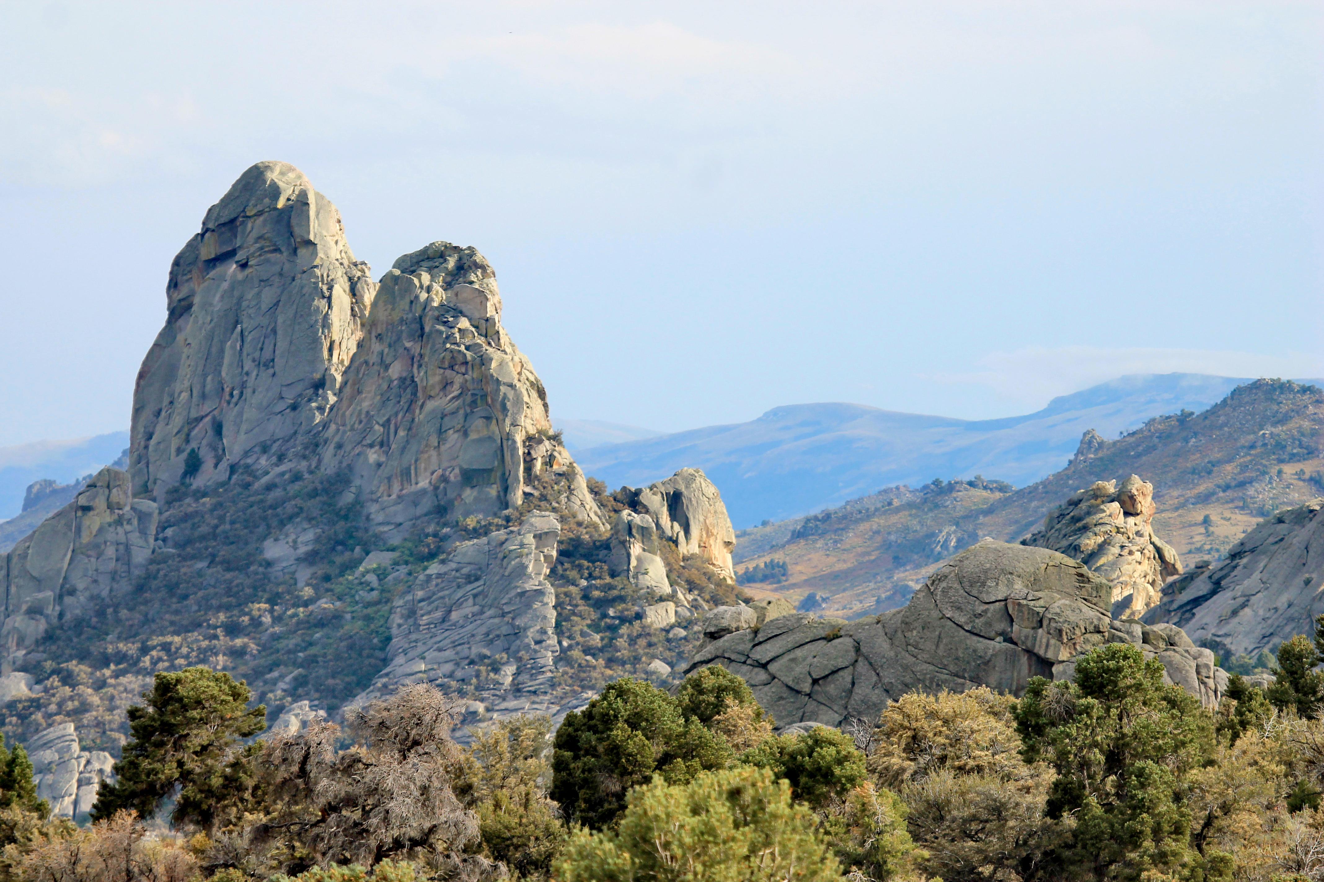 Two granite pinnacles right next to each other that are similar in size and shape.