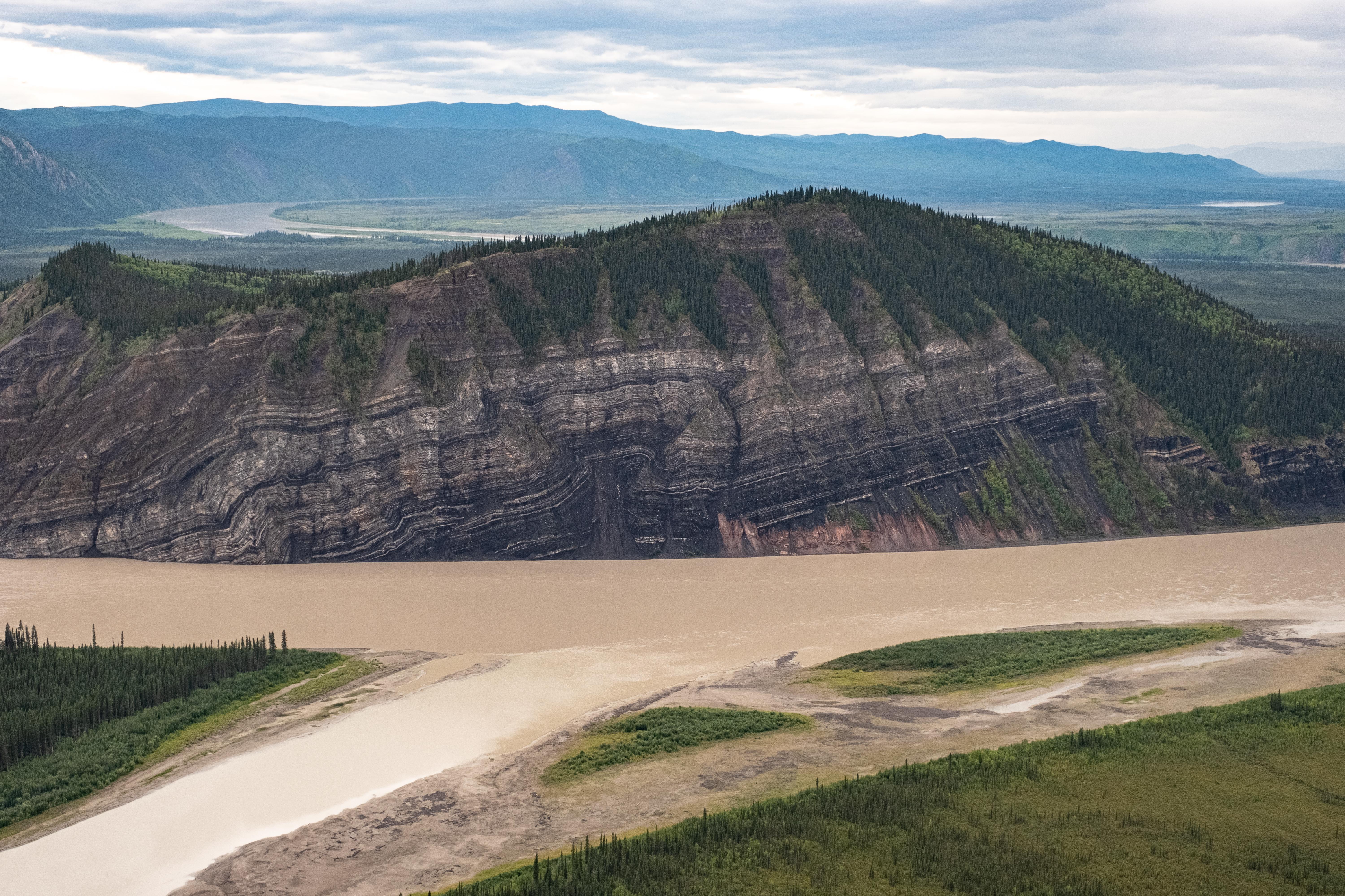Calico Bluff rising above the Yukon River that also winds into the distance behind the bluff