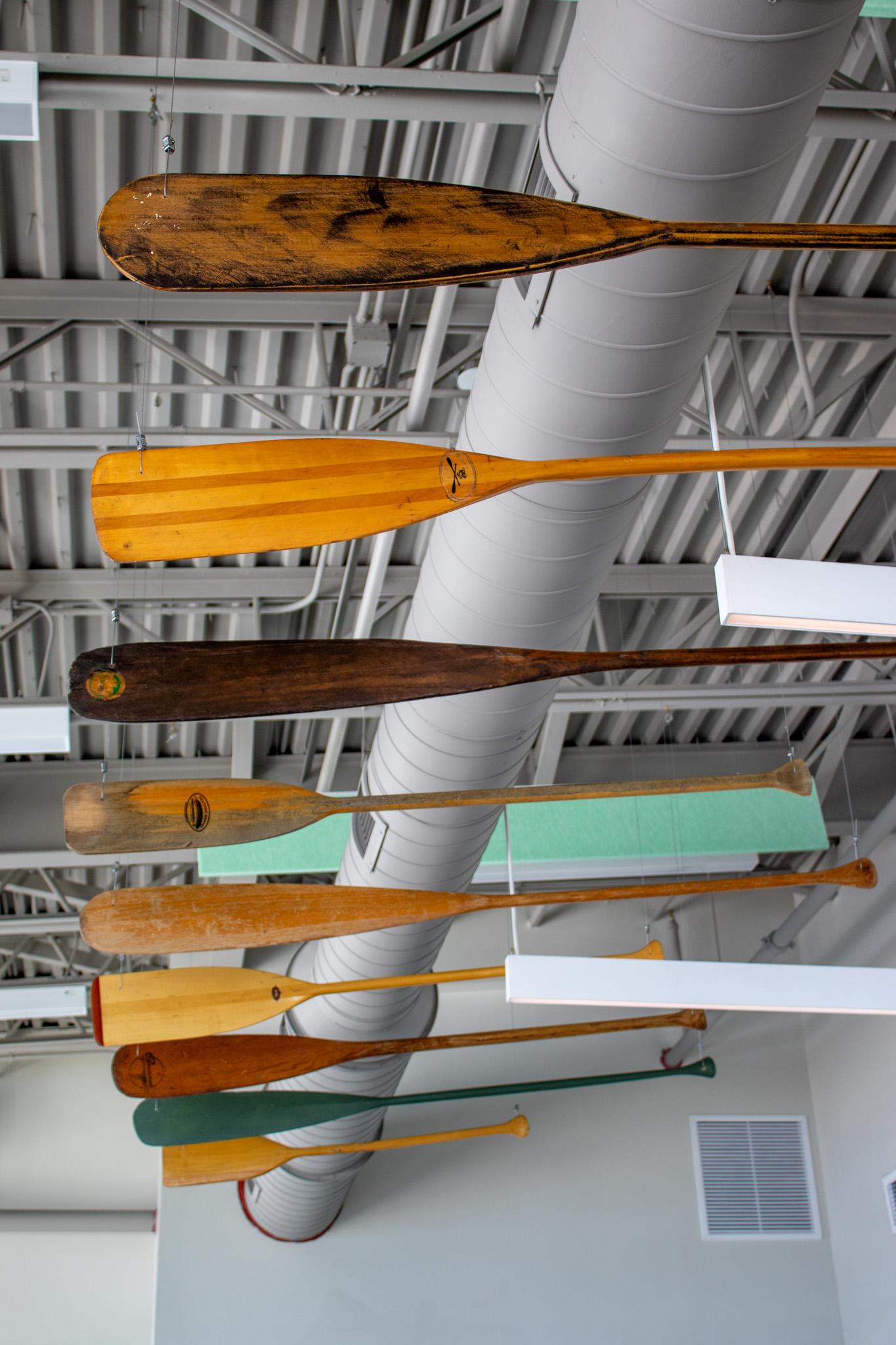 Historic canoe oars suspended in the visitor center lobby.