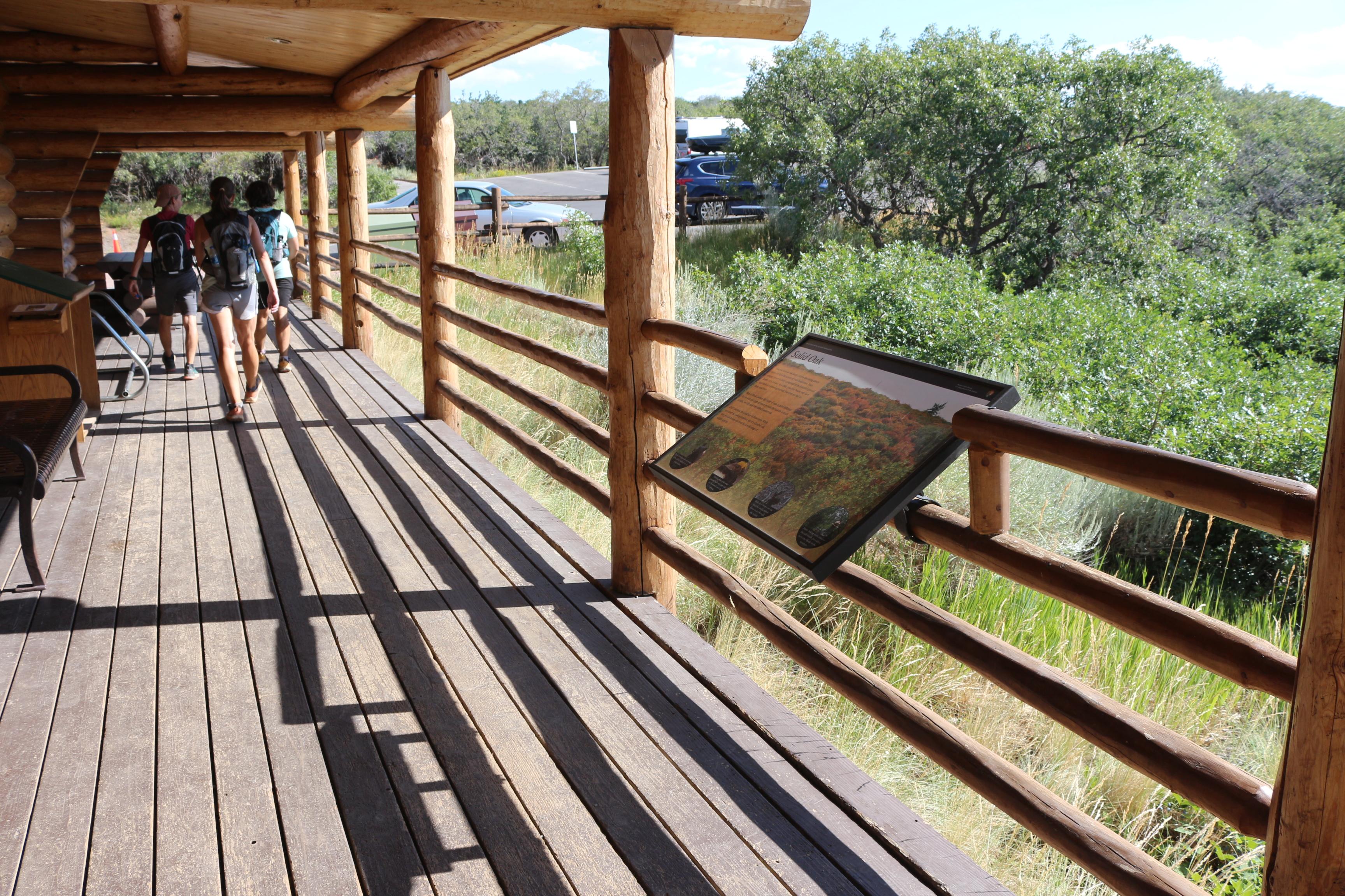 View from the wooden porch around the building with a wayside exhibit