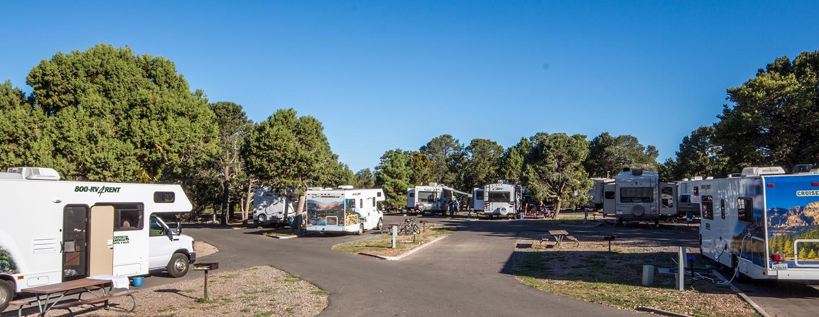 a wide panorama showing a number of RVs in individual sites.