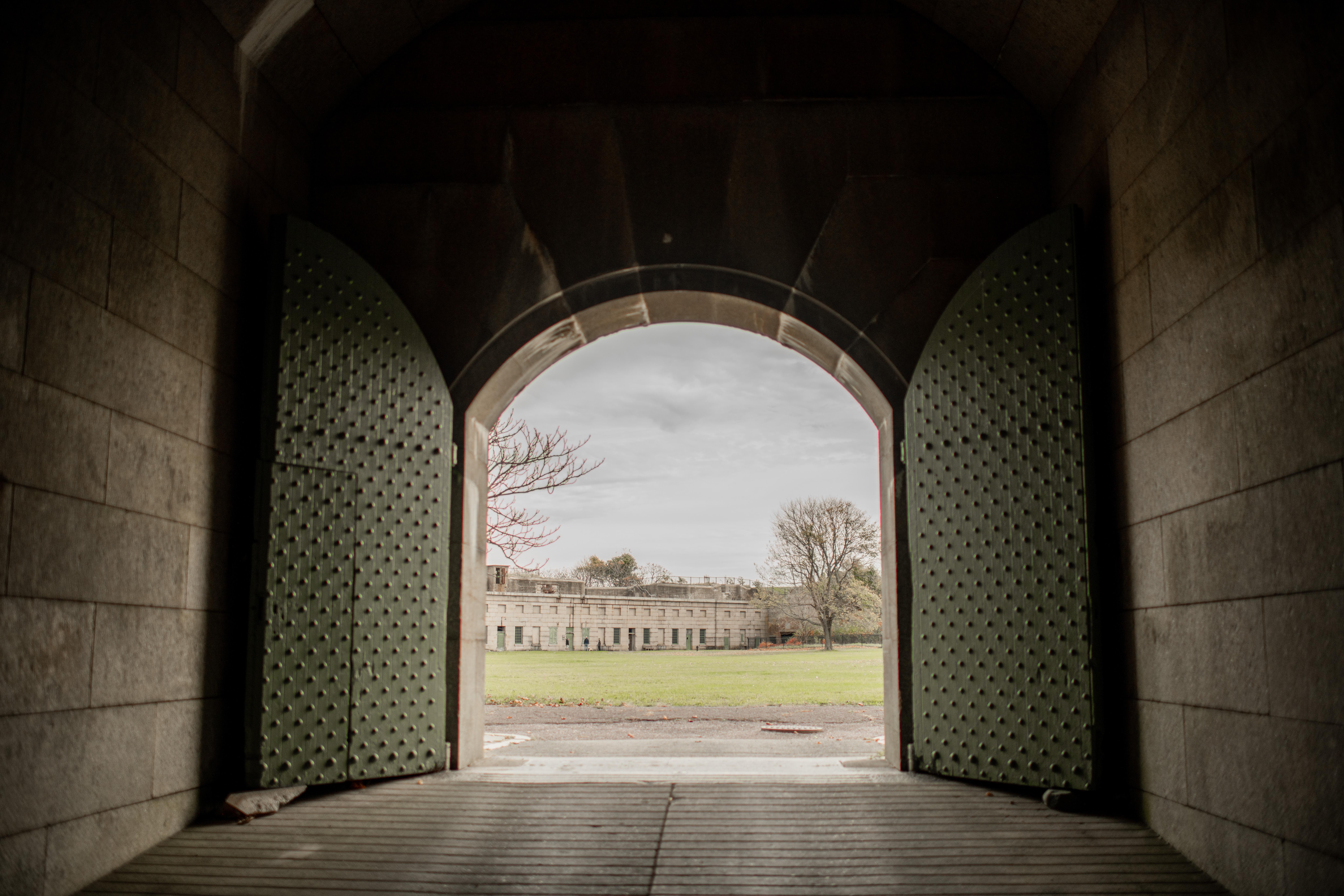 A big arched door opens to the parade ground of Fort Warren.