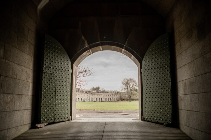 A big arched door opens to the parade ground of Fort Warren.