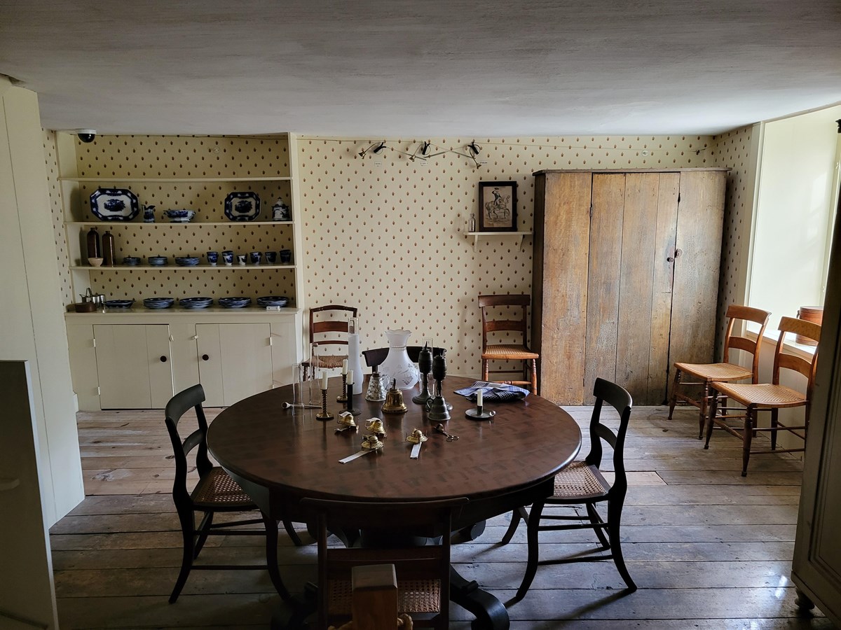 The servants' dining room in the basement of Lindenwald. A round table fill the center of the room.