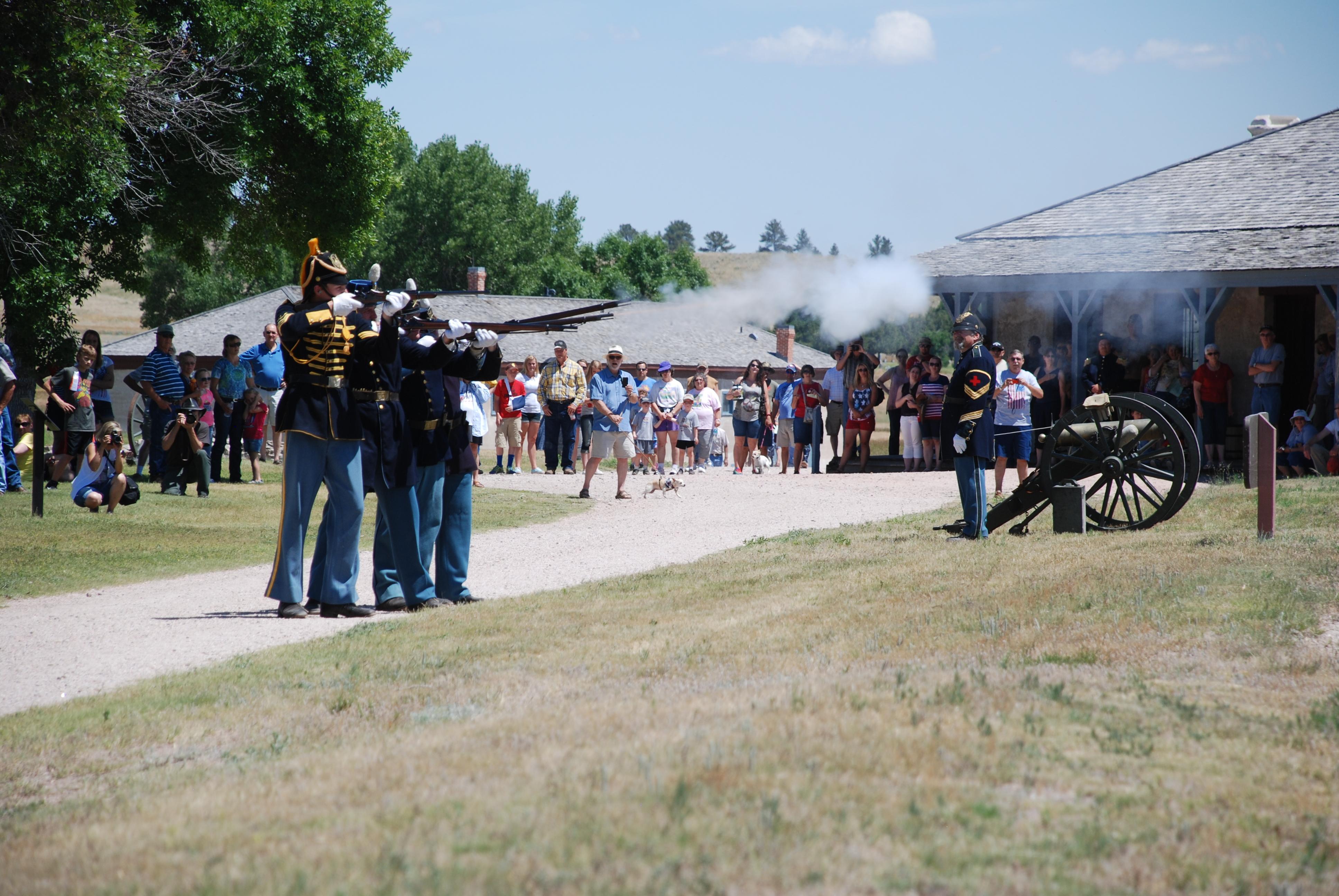 Rangers in living history clothing fire a salute with Springfield rifles for Independence Day.