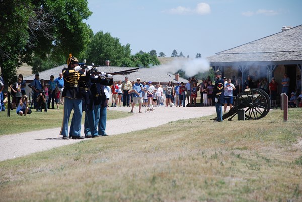 Rangers in living history clothing fire a salute with Springfield rifles for Independence Day.