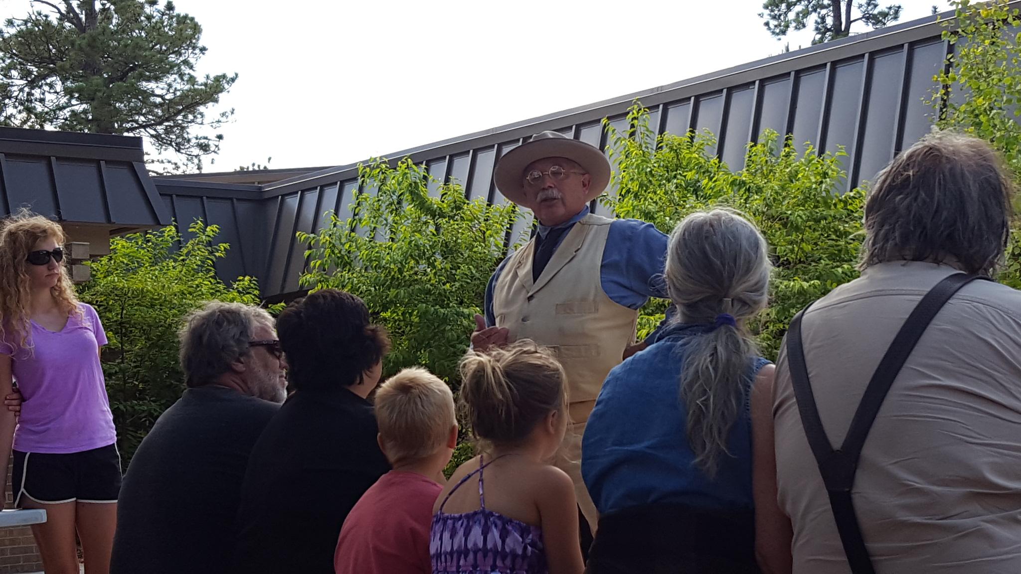A look-alike Theodore Roosevelt speaks to visitors on the patio of the visitor center.