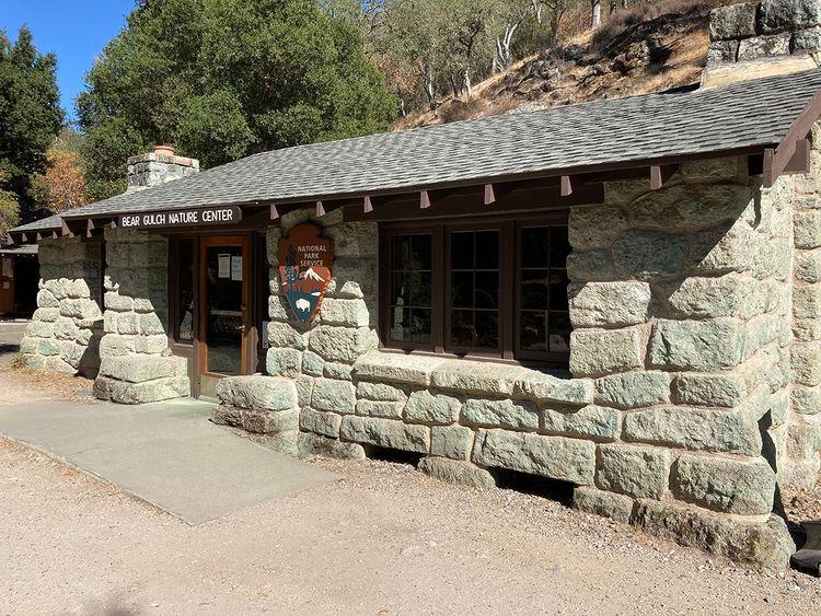 Stone building next to a chaparral covered hillside