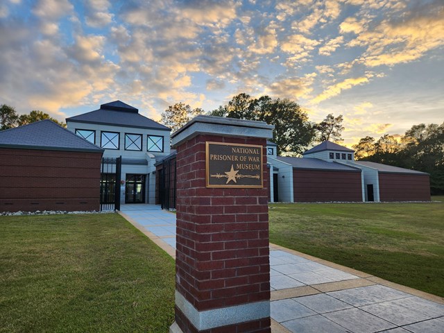 Large brick museum with a sign in front reading "The National Prisoner of War Museum"