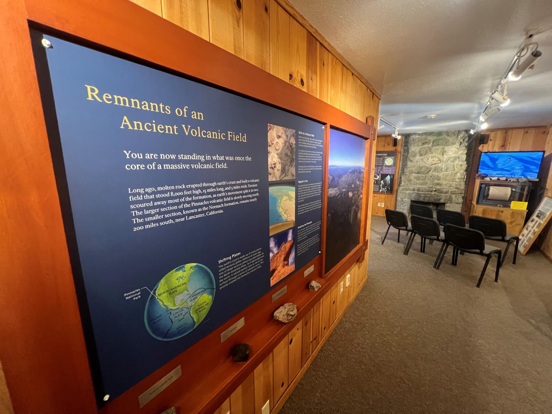 Display board that reads "Remnants of an Ancient Volcanic Field" inside a wooden and stone building