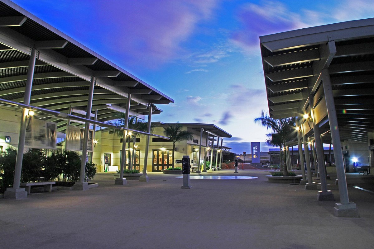 An evening photo of the Pearl Harbor Visitor Center Complex looking towards the museums. 