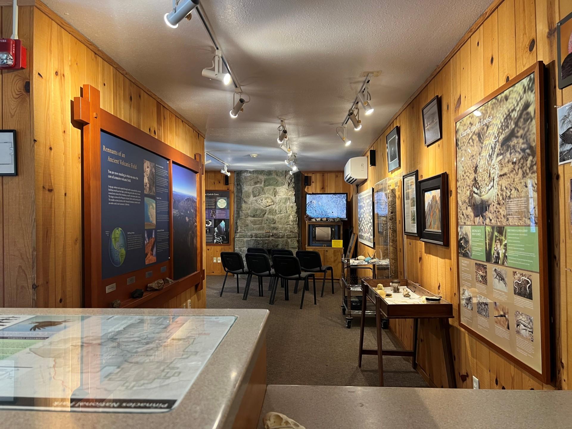 View from the front desk marble top counter with interp displays and a tv atop a seismograph