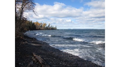 Lake Superior waves lapping the rocky shoreline of Little Todd Harbor.