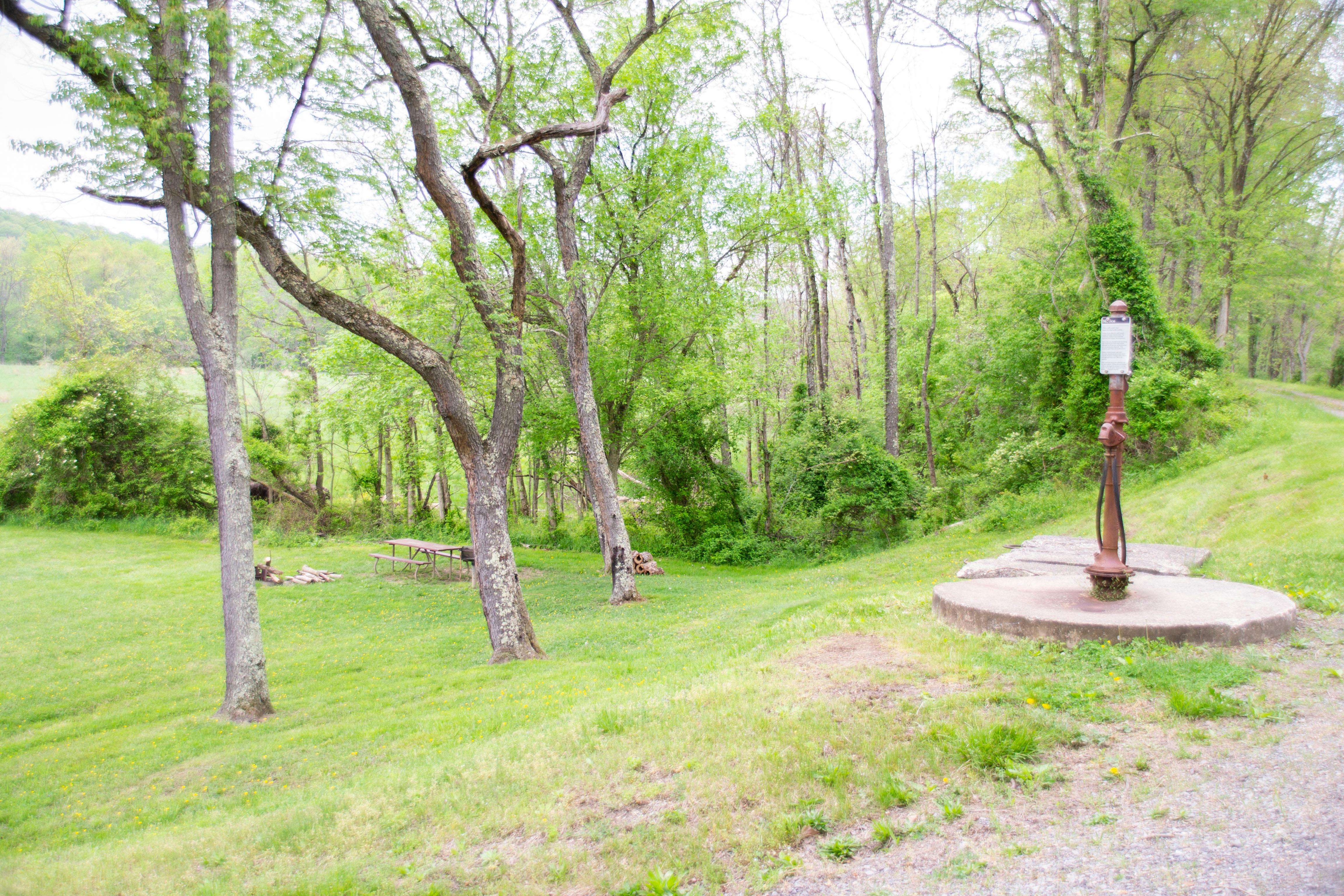 A water pump sits next to the towpath.