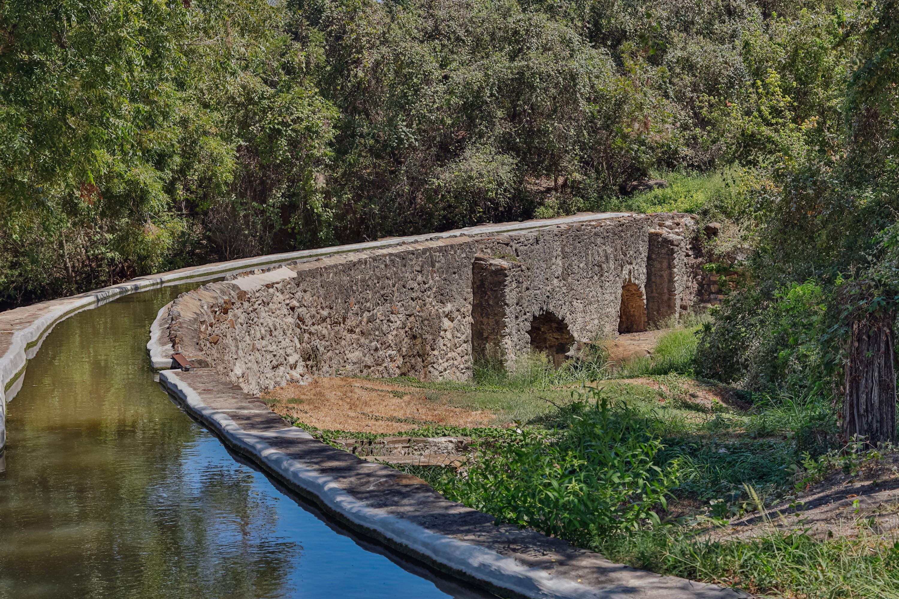 stone aqueduct with water filling the channel
