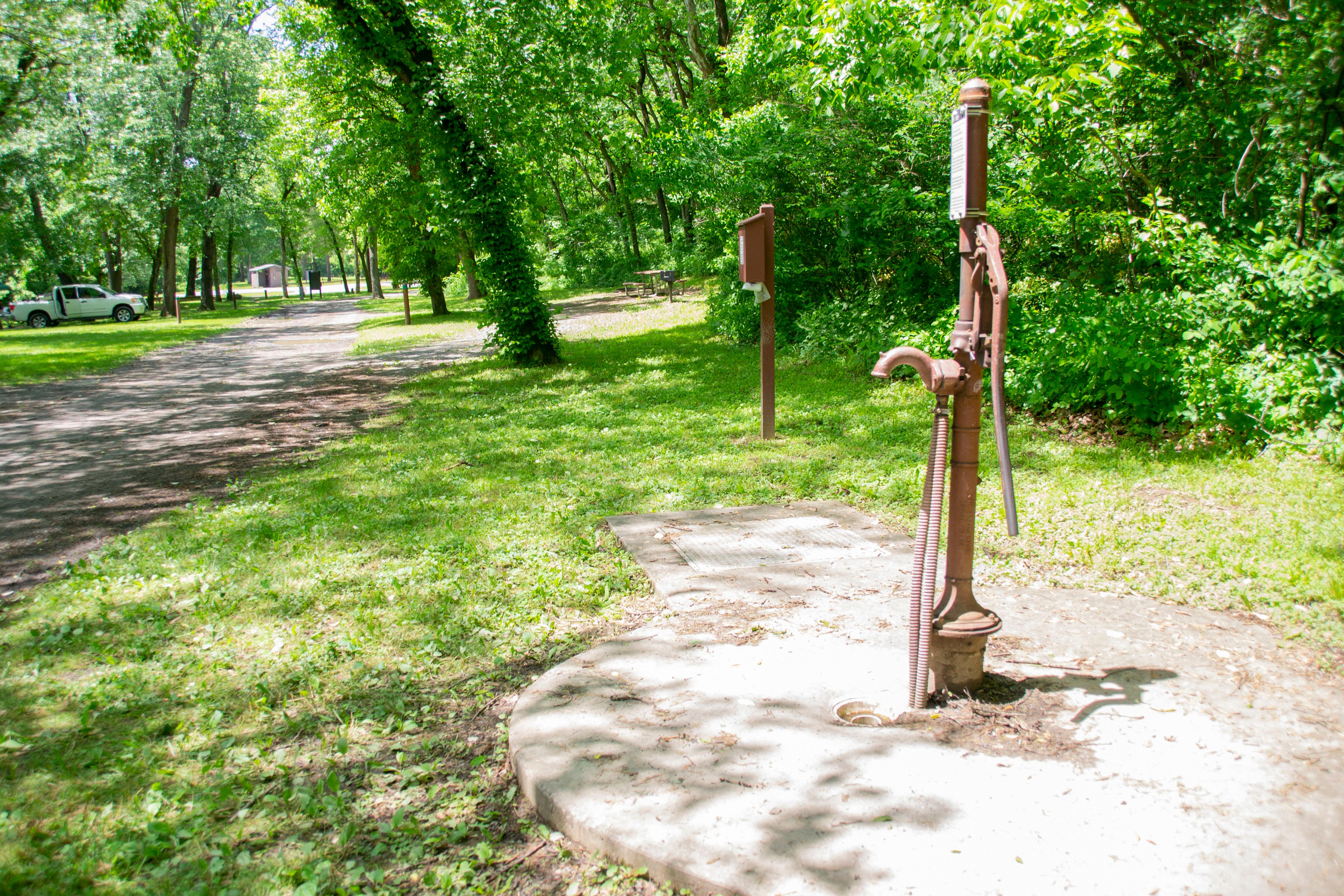 A water pump sits next to the towpath.