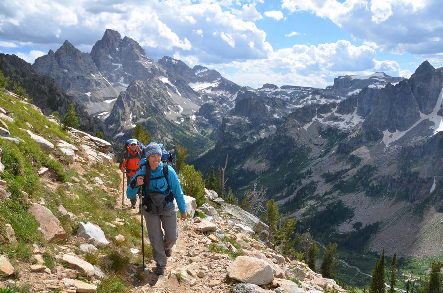 Two backpackers hiking through the mountains