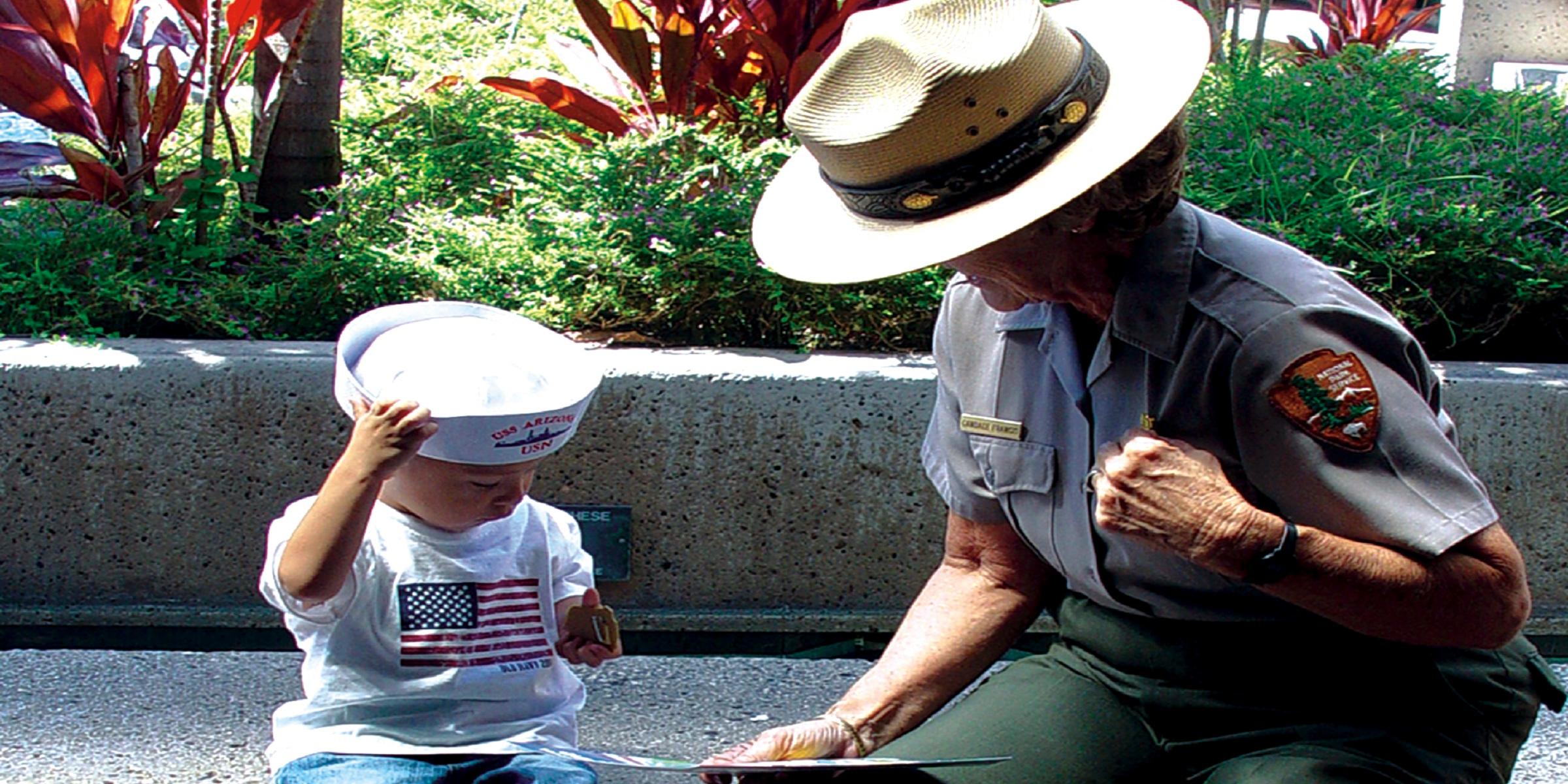 A park ranger speaking to a young visitor about the National Park