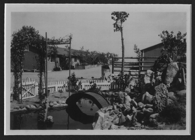 black and white image of a Japanese styled garden with a small koi pond.