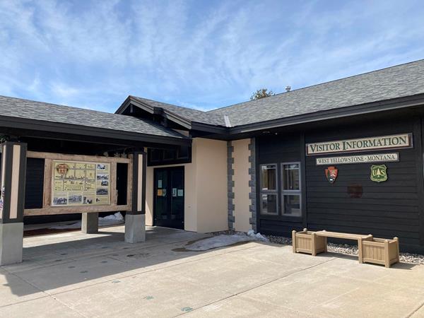 West Yellowstone Chamber of Commerce entrance with orientation sign in front of building.