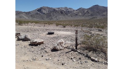 View of the mountains from unpaved road.  Fire rings are provided at each campsite.