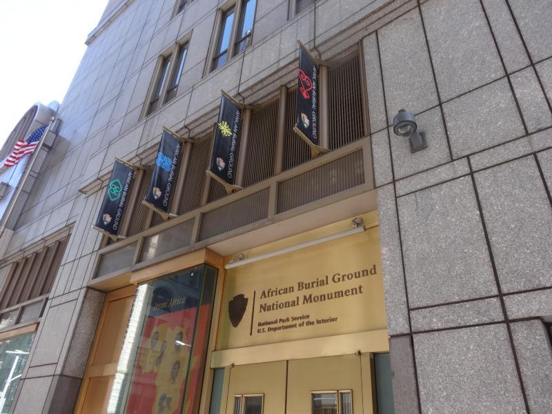 Entrance to visitor center with four banners above doorway.