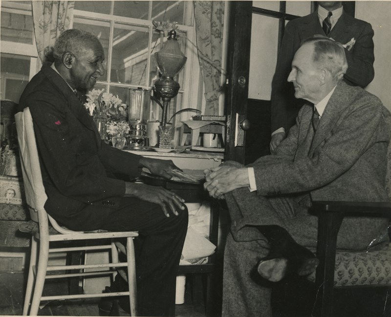 Carver with Friend and Fellow Inventor, Henry Ford George W. Carver and Henry Ford seated facing one another talking