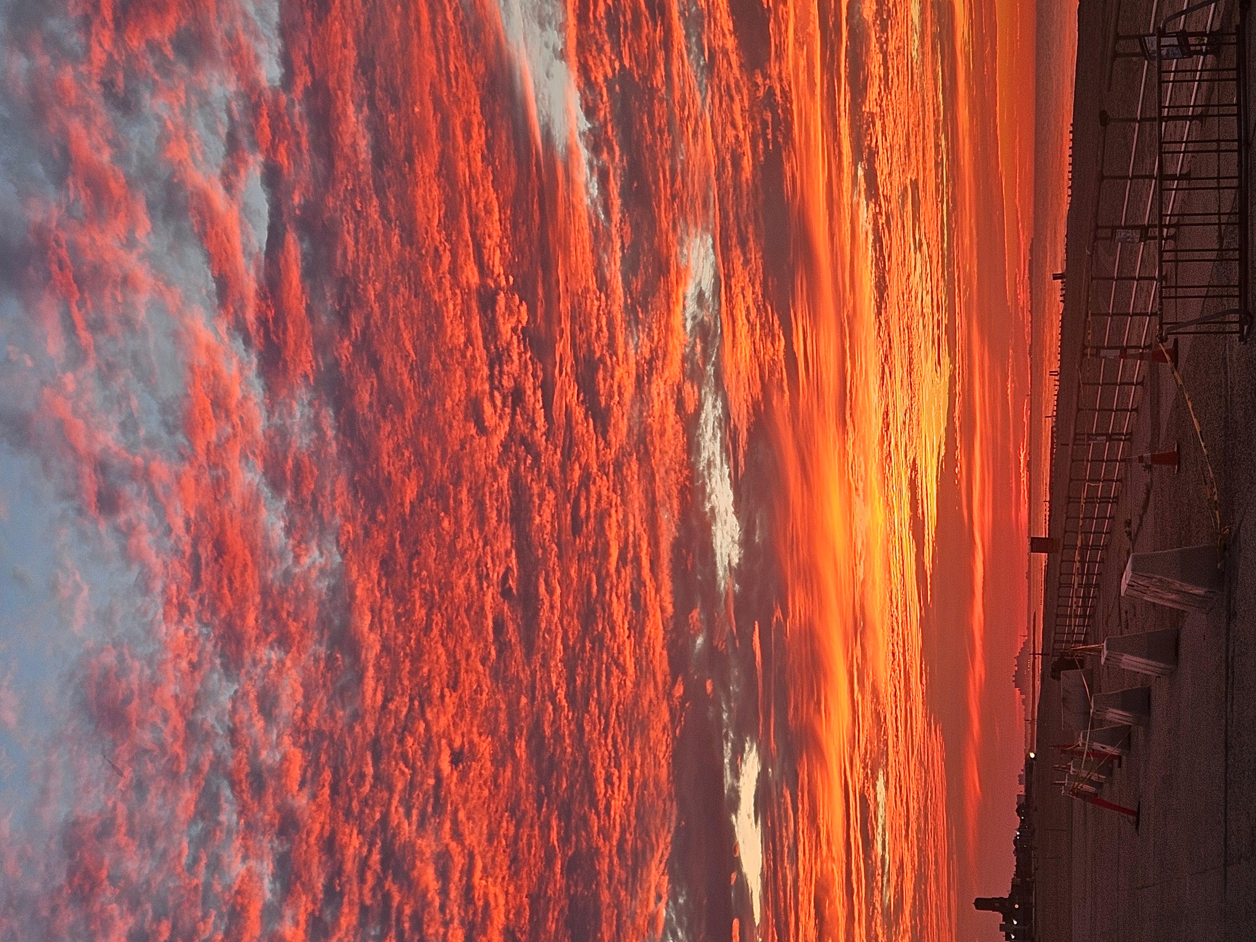 Red pink and orange sky over a body of water