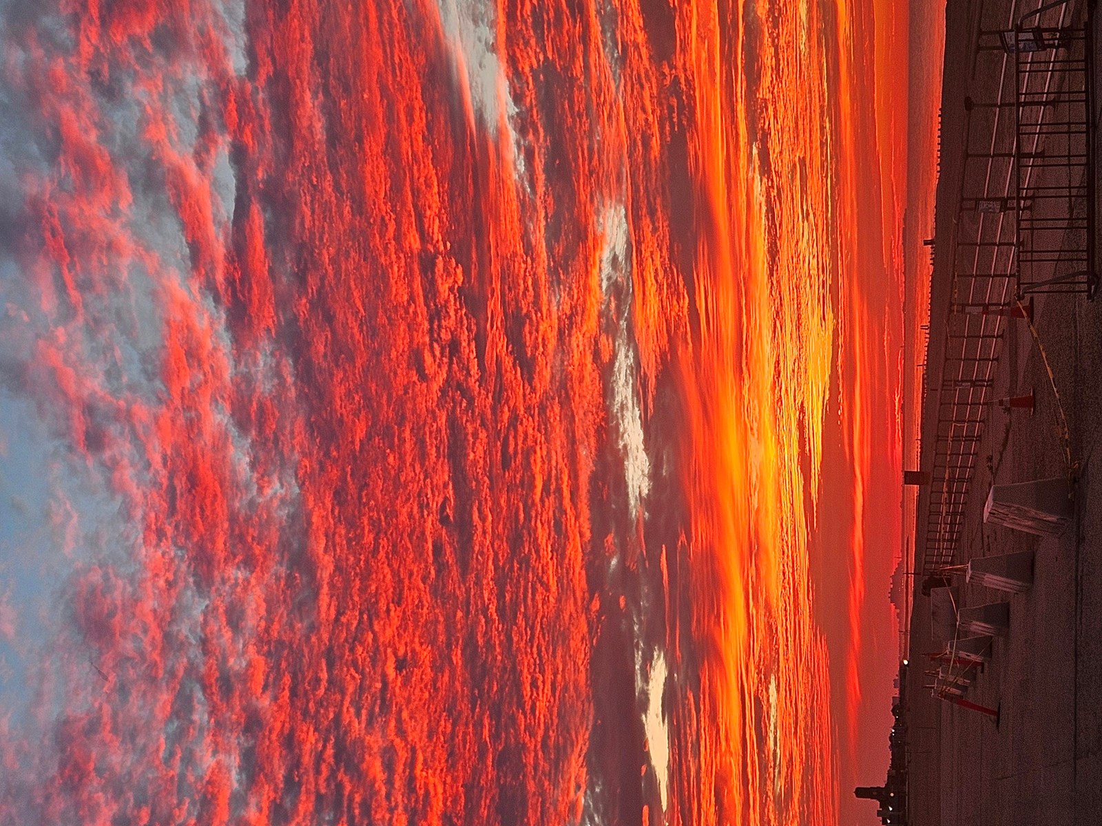 Red pink and orange sky over a body of water
