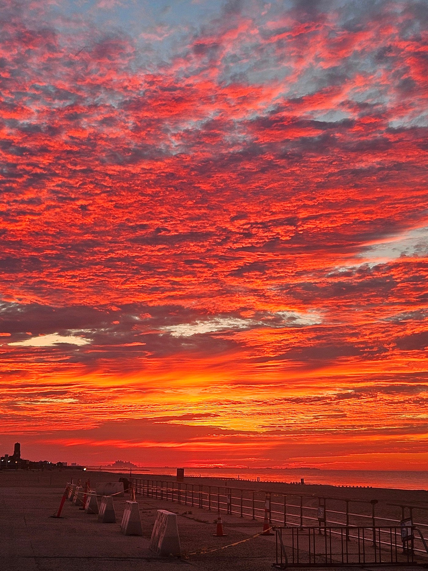 Red pink and orange sky over a body of water