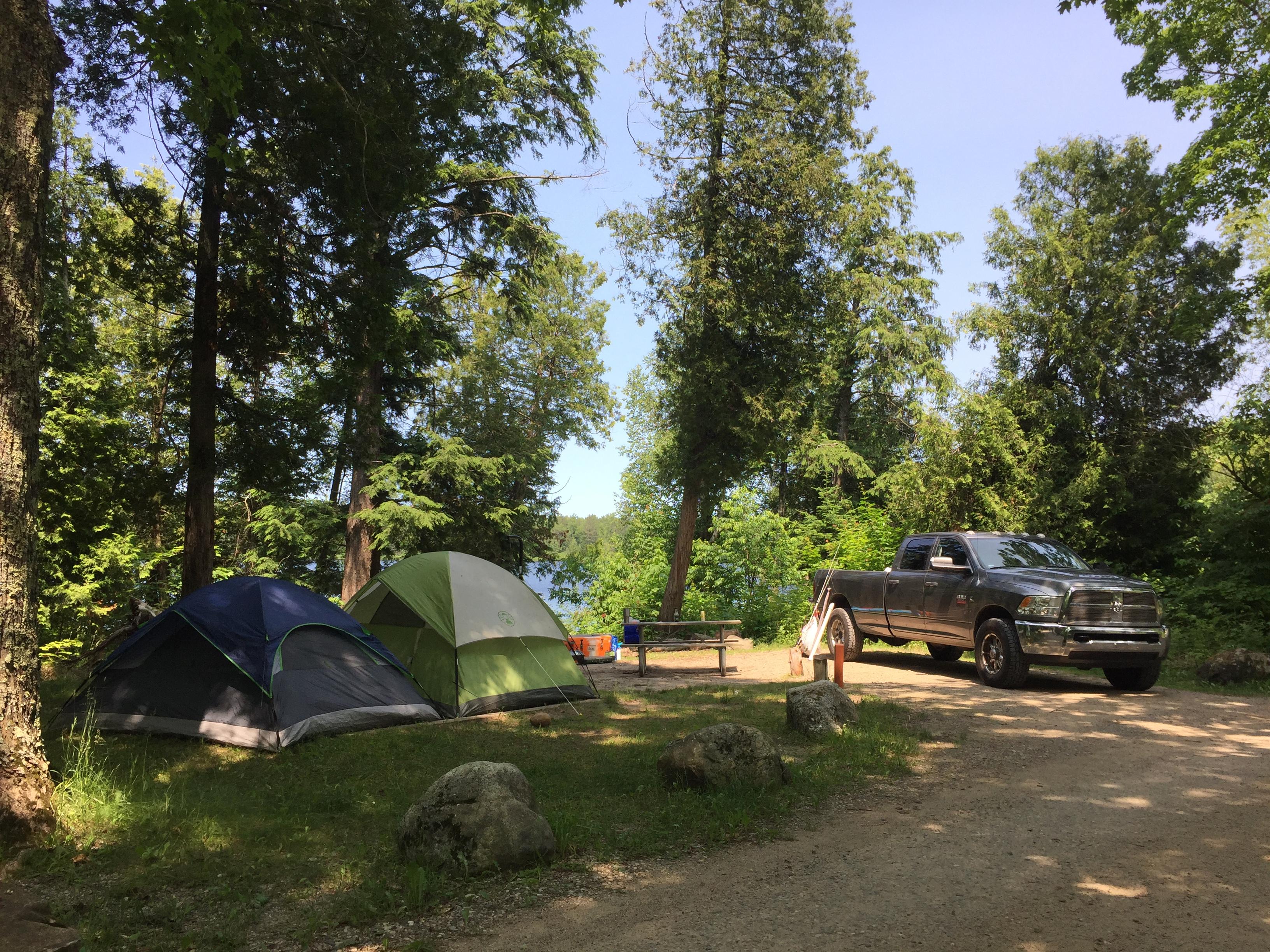 Pickup Truck and and two tents at Little Beaver Lake Campsite.