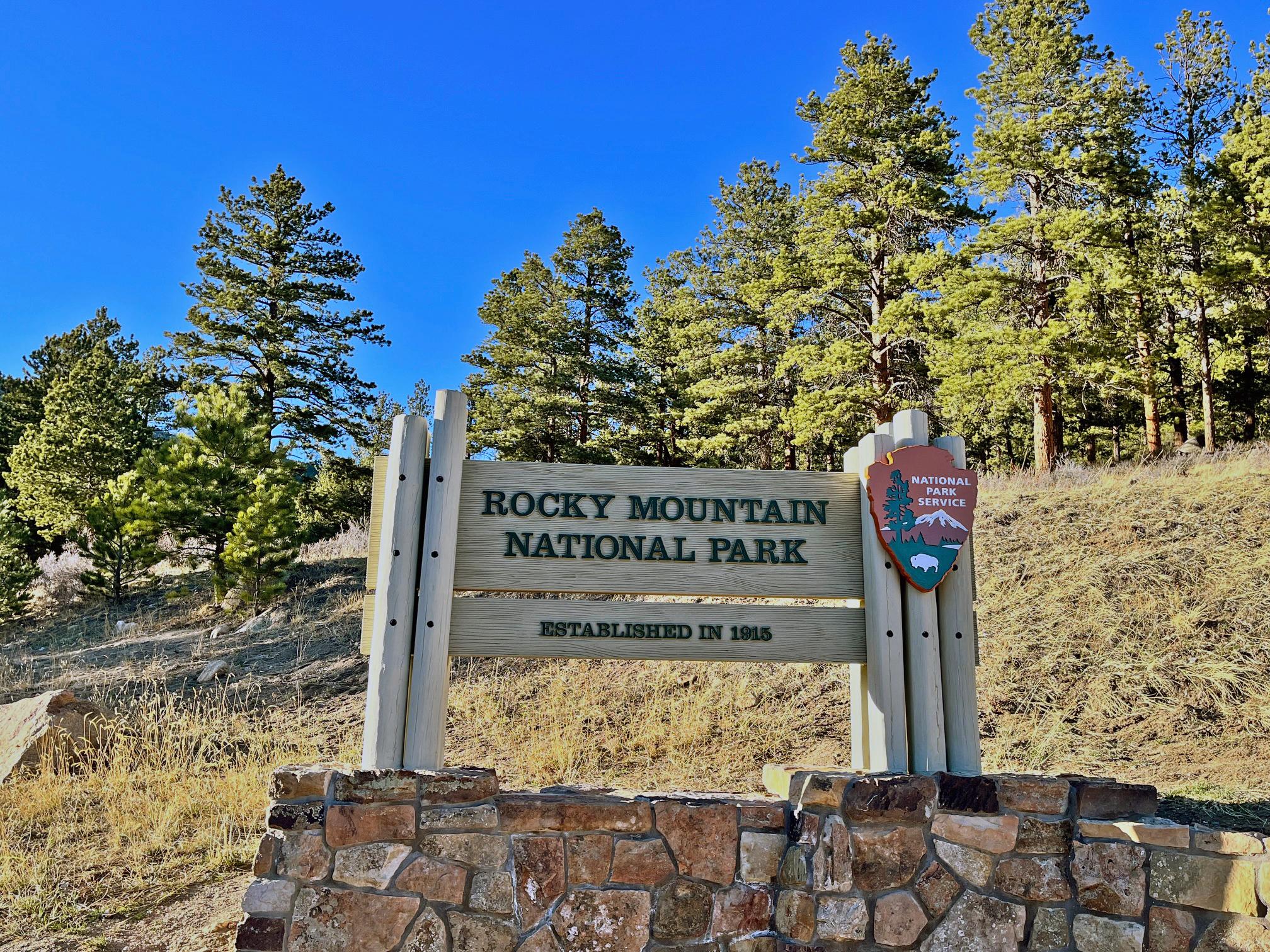 Rocky Mountain National Park Sign on a sunny day with clear sky overhead