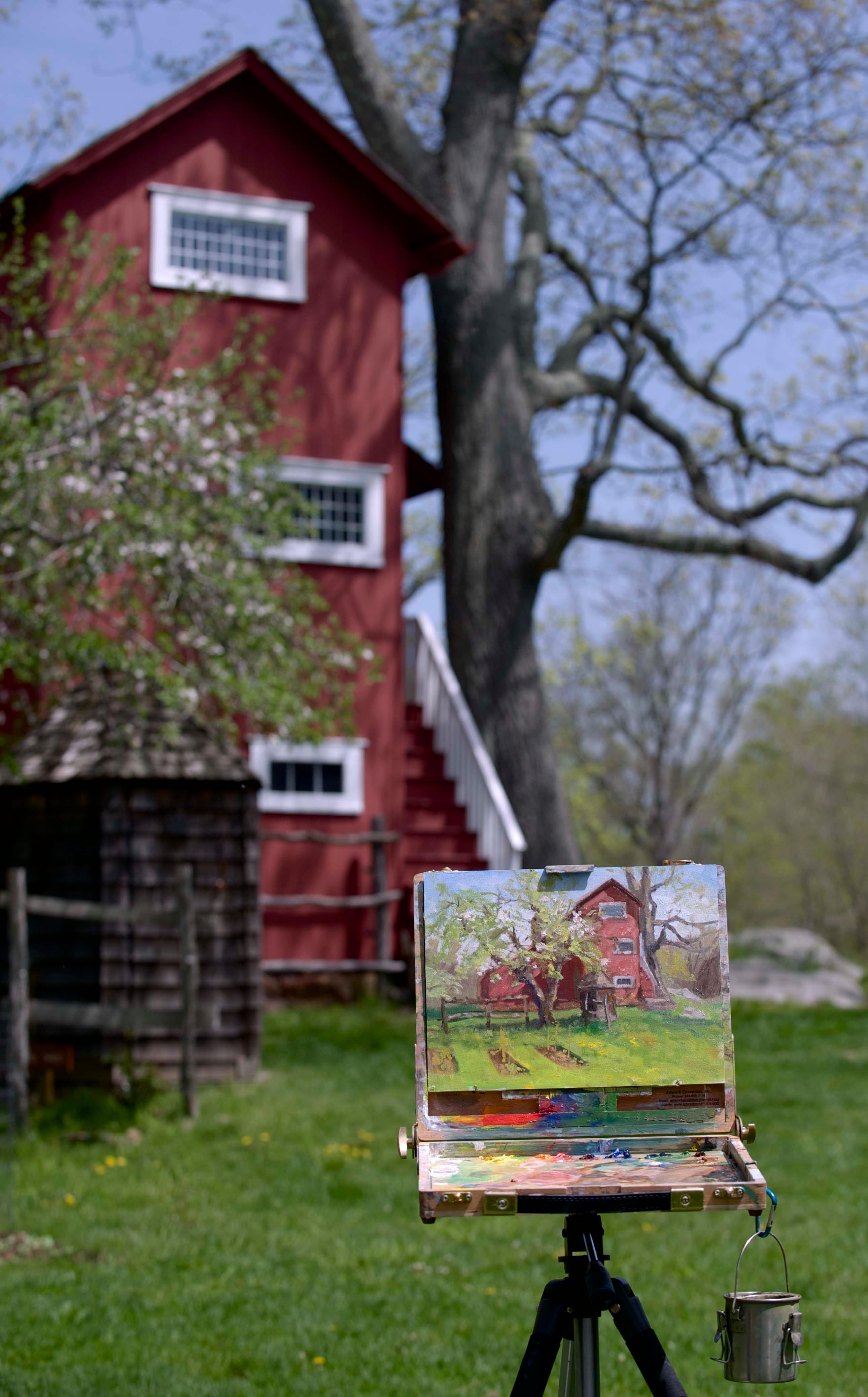 A painting of a red building with the same building in the background.