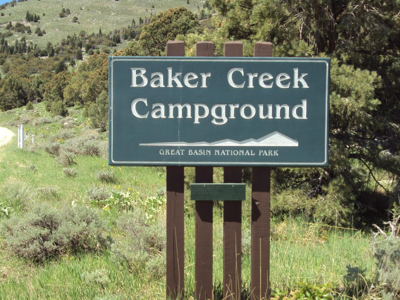 Green sign with white text "Baker Creek Campground"