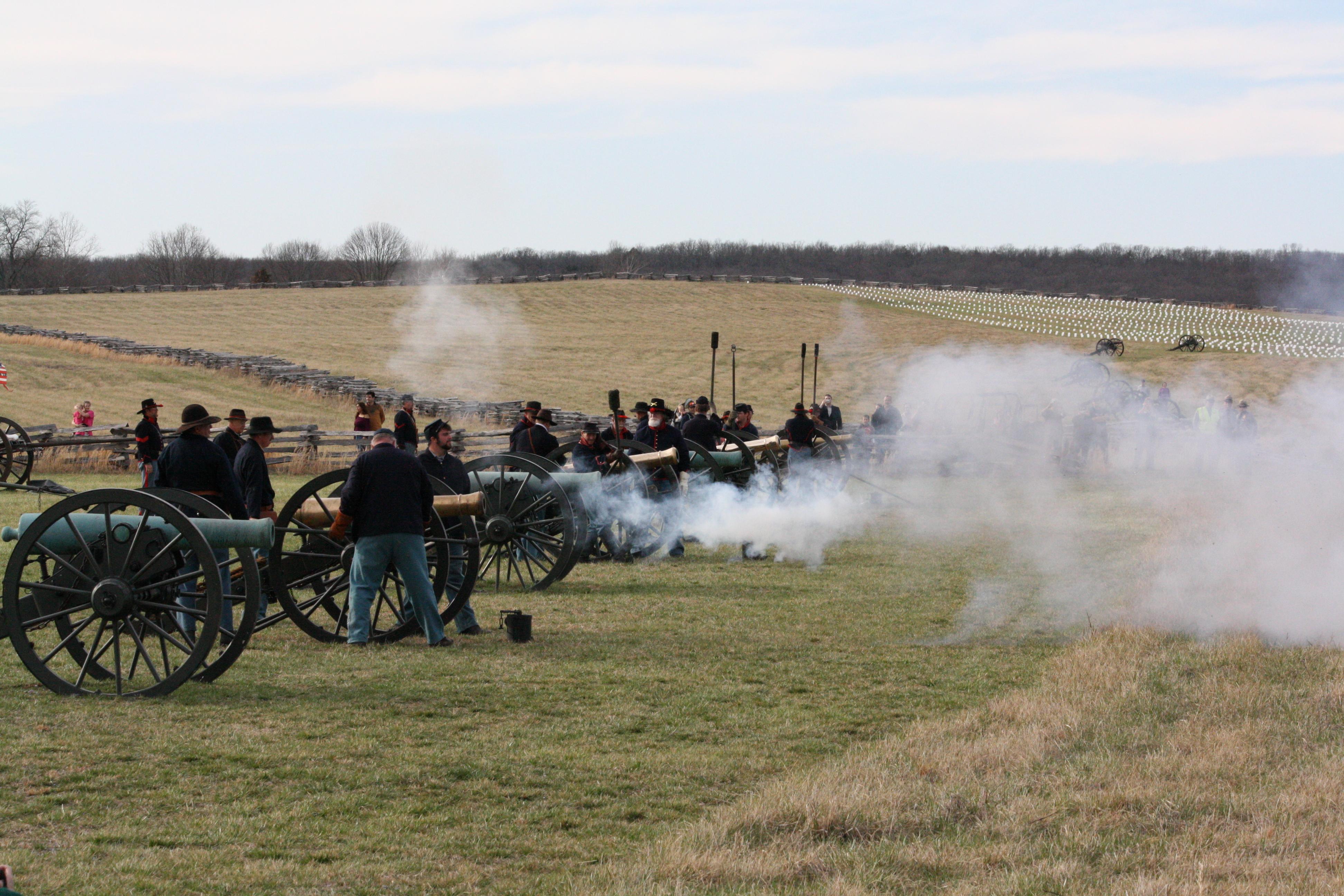 Photo of Union cannons and crew firing cannons in a field.