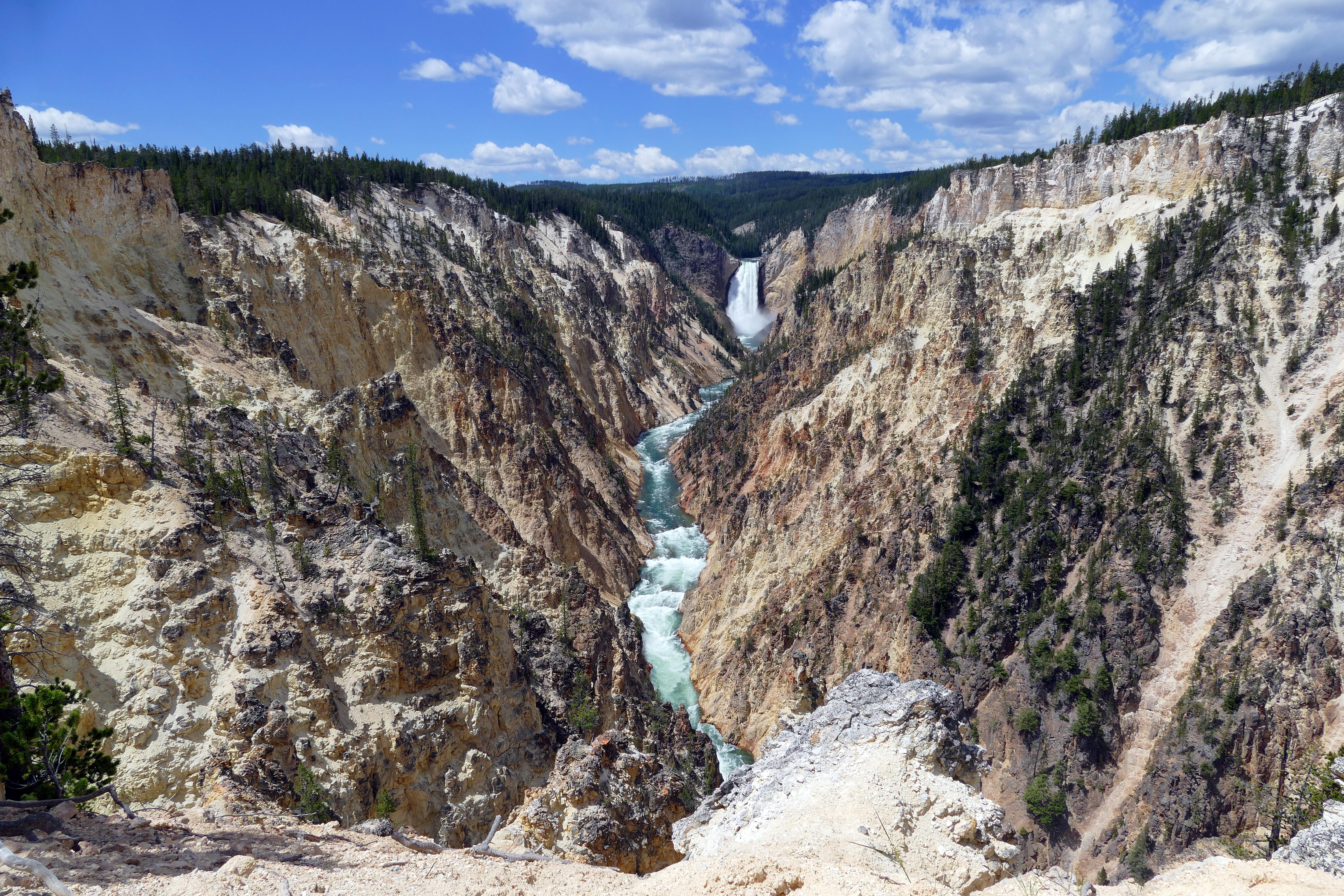 A river plunges into a steep, barren canyon.