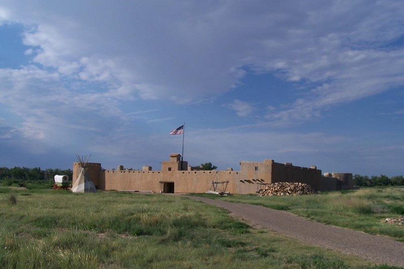 Bent's Old Fort Bent's Old Fort with shortgrass prairie, tepee and wagon in foreground and blue sky & clouds above