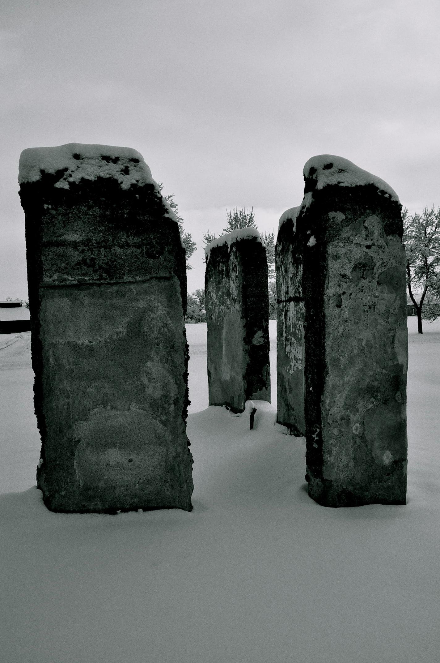 Ruins of a concrete structure with snow on top.