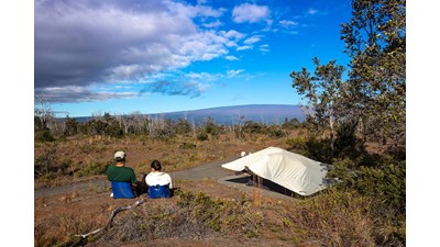 Visitors looking at Mauna Loa from a campsite