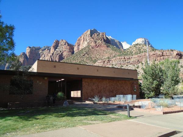 A brick building with mountains in the background
