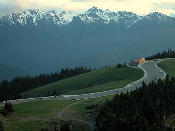 A visitor center with a mountain range in the background.
